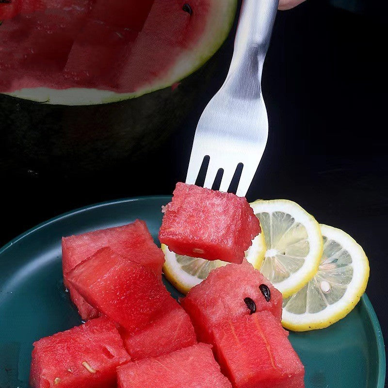 Fork cutting smooth lines in watermelon