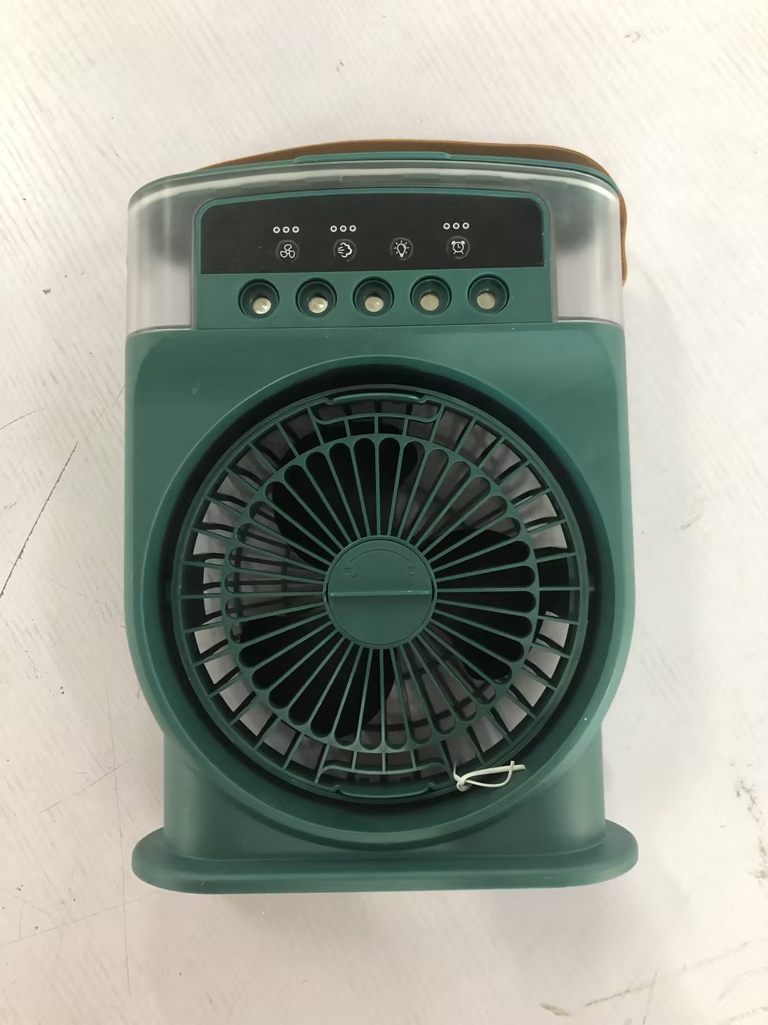 Fan placed on a desk beside a laptop